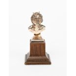 A silver-plated bust of a Bacchanalian Fawn by Omar Ramsden, modelled leaning forward, on oak