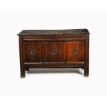 A 17th/18th century oak three panel coffer, with hinged top, carved with diamond shaped panel