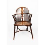 A Windsor armchair, the back with carved central splat, with crinoline stretcher, unsigned, 87cm.