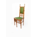 An oak chair with five legs the design attributed to Dr Christopher Dresser for retail at