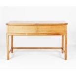 A Heal & Son oak desk designed by Ambrose Heal for his own use, the rectangular top, hinged to