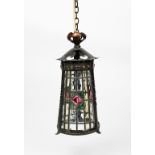 A patinated copper and leaded glass hall lantern, flaring conical frame with three leaded glass