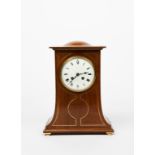 An oak mantel clock in the manner of Stanley Webb Davies, rectangular section, curved tapering