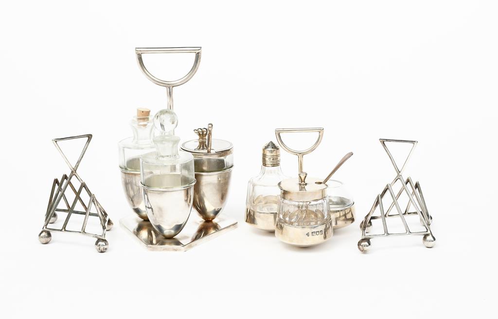 A Walker & Hall silver and glass cruet set designed by Dr Christopher Dresser, three circular well