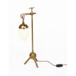 A brass table lamp in the manner of Benham & Froud, tripod foot supporting ball, cylindrical stem