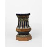 A stoneware jardiniere stand or garden seat probably Doulton, modelled with bands of foliage and