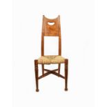 A William Birch rush-seated chair, with turned front legs, curved square section back legs, the