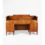 A Heal's fumed oak desk made in 1904 for Ambrose Heal's office, rectangular top with leather, long