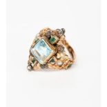 A gold, silver and aquamarine ring the design attributed to Arthur and Georgie Gaskin, double gold