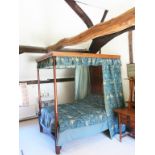 A Heal's oak four-poster bed, panelled head board with turned columns, adorned with Morris & Co Bird