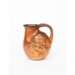 A Martin Brothers salt-glaze stoneware face jug by Robert Wallace Martin, dated 1899, modelled in