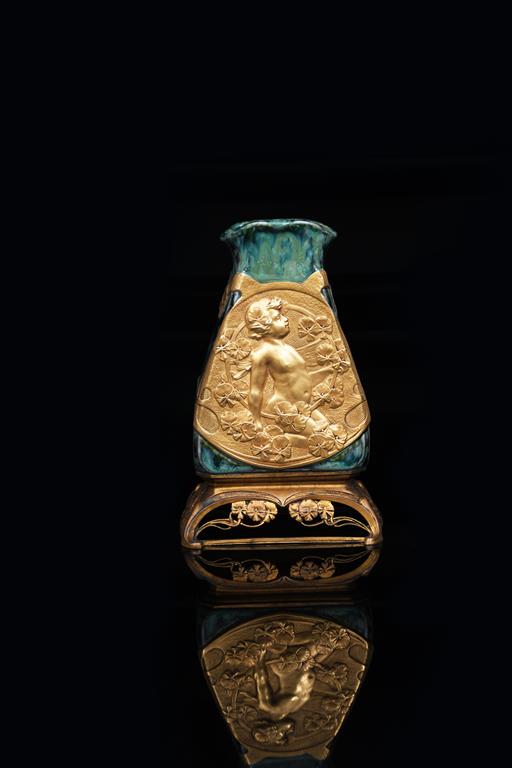 An Art Nouveau porcelain vase on gilt bronze mount by Charles Korschann, the tapering body with