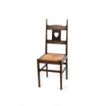 A rare oak side chair designed by Charles Francis Annesley Voysey, the oak frame back with