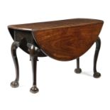 A GEORGE II MAHOGANY DINING TABLEC.1740 the oval drop-leaf top on hocked cabriole legs and claw