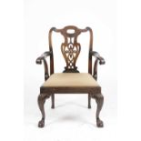 A GEORGE II MAHOGANY ARMCHAIR C.1750 with a pierced vase shaped splat above scrolled arms, and