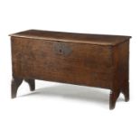 A BOARDED OAK COFFER EARLY 17TH CENTURY the interior with a lidded till, on ogee cut-out ends 51cm