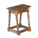 A CHARLES II OAK JOINT STOOL LATE 17TH CENTURY AND LATER the seat with a moulded rim on turned