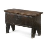 A SMALL BOARDED OAK COFFER EARLY 17TH CENTURY the interior with an open till, on cut-out ends 41.2cm