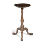 A GEORGE III TRIPOD TABLE C.1770 the circular dished fruitwood top above an oak base 68.5cm high,