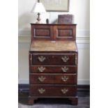 A SMALL GEORGE II MAHOGANY BUREAU CABINETC.1740-50 the top with a pair of fielded panelled doors,