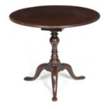 A GEORGE II MAHOGANY TRIPOD TABLE C.1740-50 the circular tilt-top revolving on a birdcage, on a ring