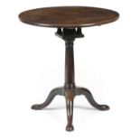 A GEORGE II MAHOGANY TRIPOD TABLEC.1740 the circular tilt-top revolving on a birdcage68.5cm high,