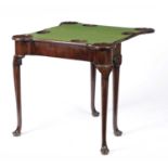 A GEORGE II MAHOGANY CARD TABLE C.1740 the baize lined interior with sunken counterwells and