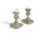 A PAIR OF GILT BRONZE CANDLESTICKS IN LOUIS XV STYLE, 19TH CENTURY the Rococo urn nozzles on short
