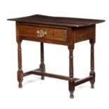 AN OAK SIDE TABLELATE 17TH / EARLY 18TH CENTURY fitted with a frieze drawer, on turned legs united