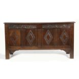 AN OAK COFFER LATE 17TH / EARLY 18TH CENTURY the plank top enclosing a till above an arch-carved