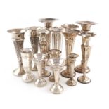 A collection of silver trumpet vases,various dates and makers,comprising: five pairs and four single