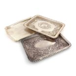 A collection of three silver dressing table trays,Chester 1904, 1918, and Birmingham 1922,