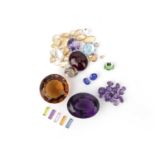 A group of unmounted gemstones; comprising: a cushion-shaped tsavorite garnet weighing 2.09