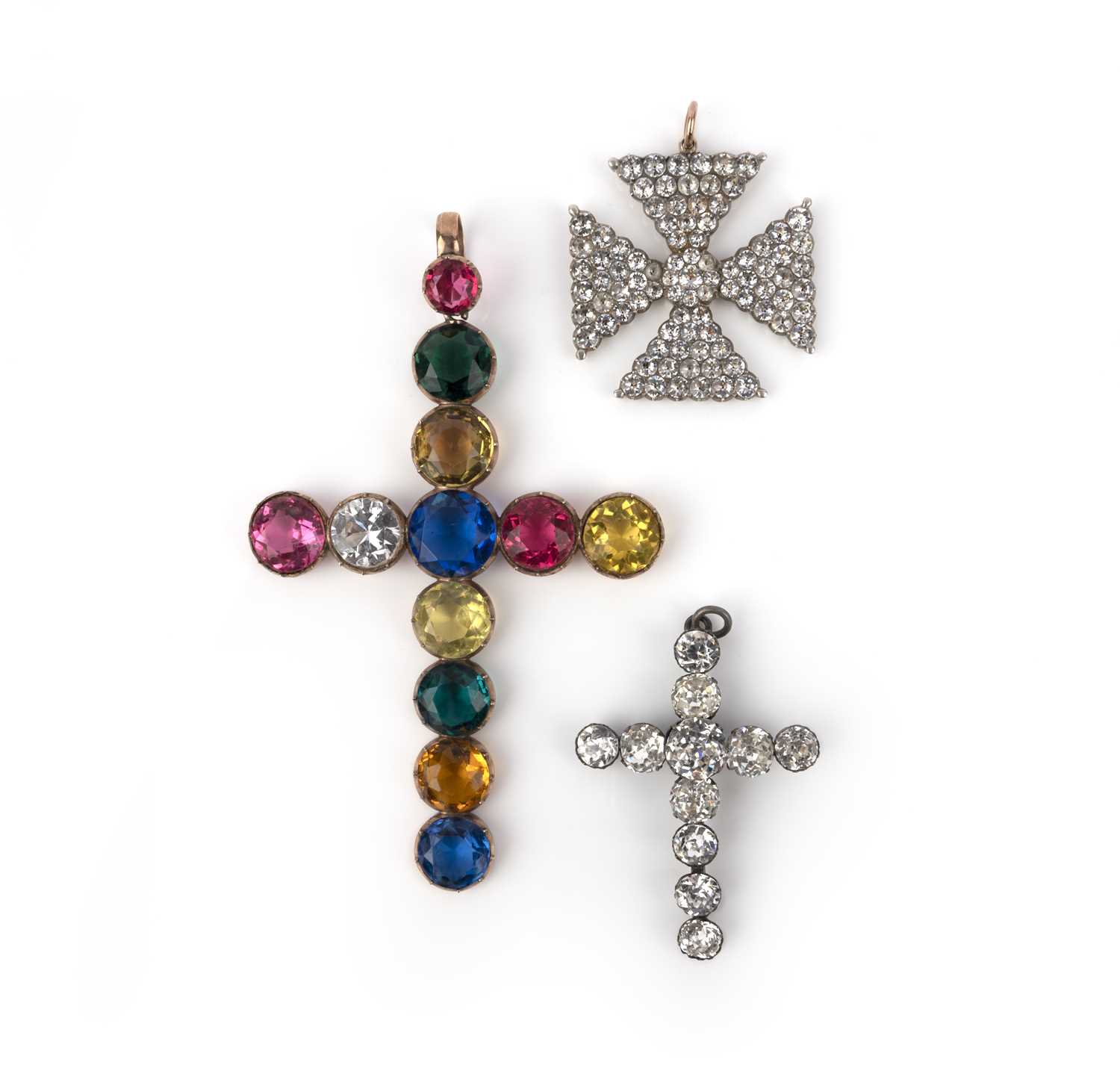 Three paste cross pendants, 19th century, comprising: one cross pendant set with multicoloured