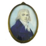 λ English School 18th Century Portrait miniature of a gentleman in a blue coat Oval, in a gilt metal