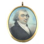 λ English School 18th Century Portrait miniature of a gentleman wearing a black coat, his powdered