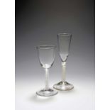 A large wine glass and an ale glass, c.1750-60, the wine glass with a round funnel bowl over a mixed