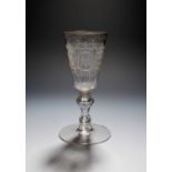 A Dutch engraved armorial glass, mid 18th century, the tall bowl engraved with seven armorial