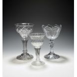 Three sweetmeat glasses, mid 18th century, two with honeycomb moulding to the bowls, raised on