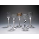 Five small wine glasses, c.1760-70, four with ogee bowls raised on multi-series opaque twist