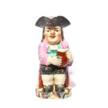 An 'Ordinary' Toby jug of Enoch Wood type, c.1800, seated with a large round jug of ale and