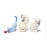 Two Herend figures of cats, modern, one playing with a ball, its coat decorated in blue scale, the