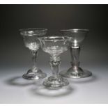 Three sweetmeat glasses, c.1740-50, two with moulded bowls, raised on pedestal stems above domed and