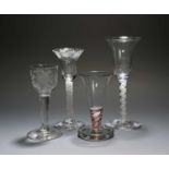 Three wine glasses and a firing glass, c.1750-70, two with bell bowls over opaque twist stems, one
