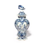 A Delft vase and cover, 18th century, the flattened hexagonal form painted on one side with an