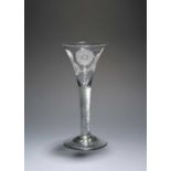 A large wine glass of Jacobite significance, c.1740, the drawn trumpet bowl engraved with a rose and
