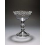 A rare champagne or mead glass, c.1750, the bowl engraved with a formal floral and foliate border,