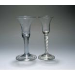 Two wine glasses, c.1740-60, with bell bowls, one raised on a thick plain stem above a folded