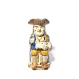 A Pratt ware Toby jug, c.1790, seated with a foaming jug of ale, his long-stemmed pipe resting