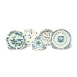 Five delftware plates, c.1740-60, one painted with bamboo and peony, another with a formal floral
